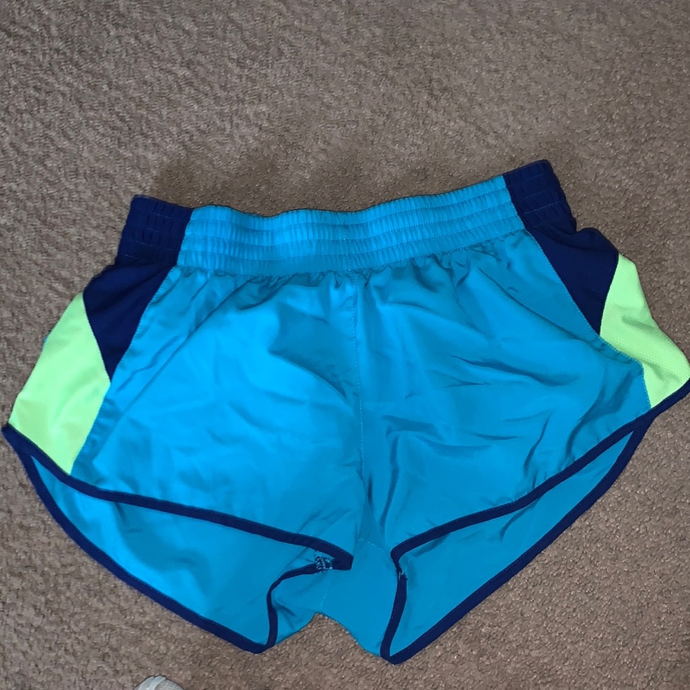 blue, green and dark blue nike running shorts